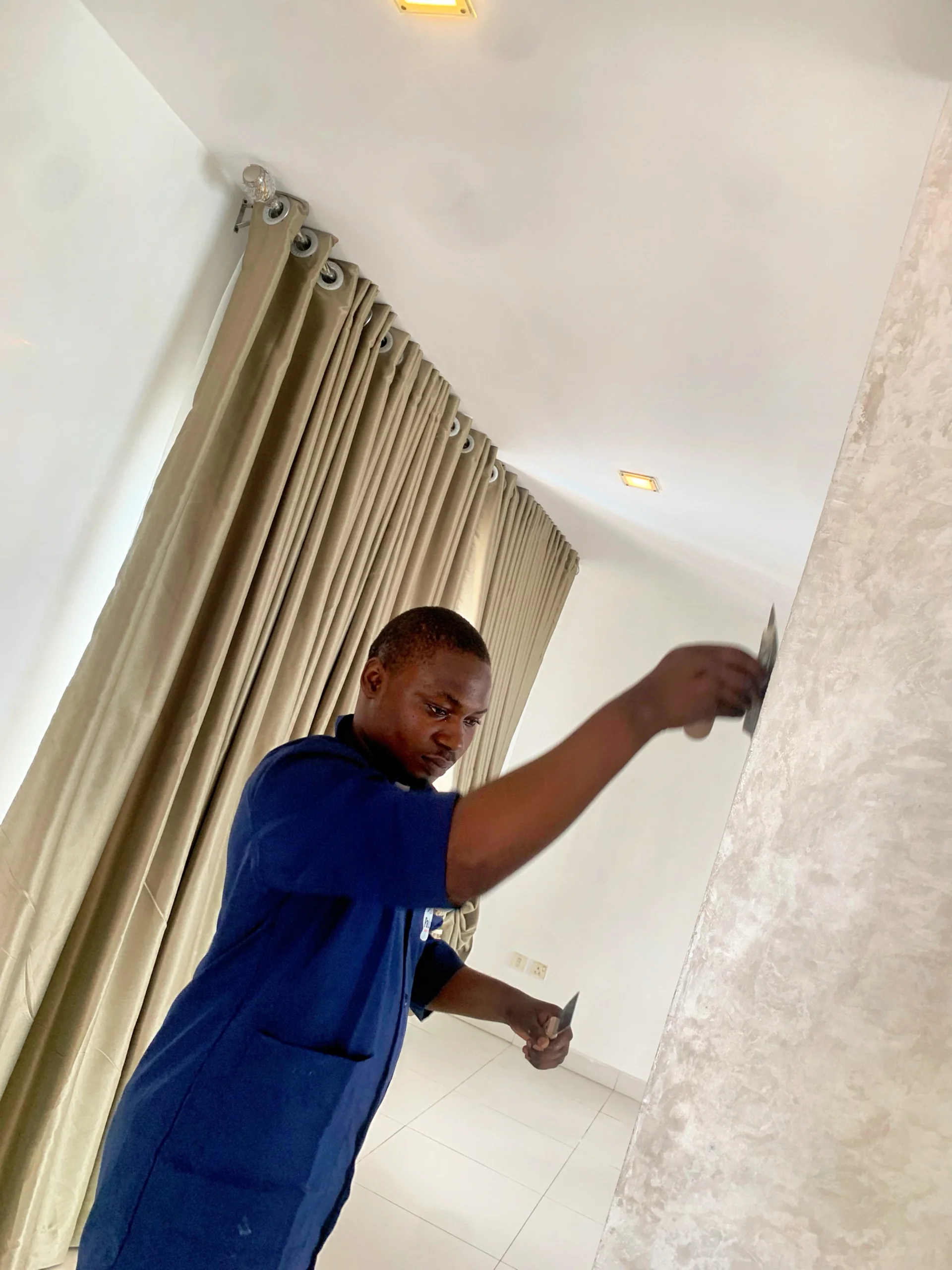 Professional painter applying premium paint to a wall surface
